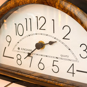 Junghans mantel clock, close-up of ivory dial and wood-effect frame