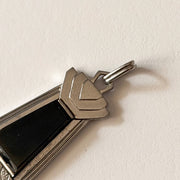 Detail of architectural silver-plated setting and genuine black onyx of GIROR pendant