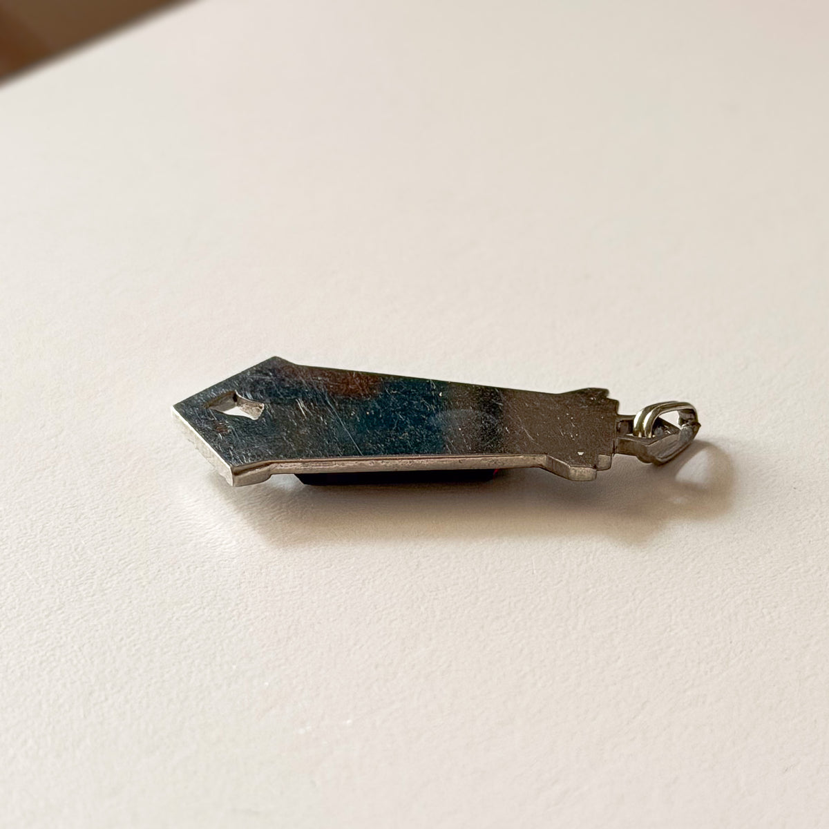 Side profile of GIROR antique black onyx pendant showing depth and construction