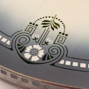 Detail of the green white floral ceramic design on antique Max Dannhorn tray